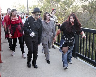 William D. Lewis the Vindicator   Zombies cross Mahoning River during Zombie Crawl.