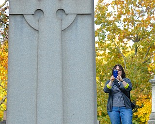 Jeff Lange | The Vindicator  Canfield resident Tammy Toti stops to photograph the Henry Wick Cross, Saturday afternoon during guided tours of Oak Hill Cemetery.
