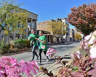 Jeff Lange | The Vindicator  Friends from work, Kelley Secrest of Austintown (left) and Kimberly Franke of Campbell keep each other company as they make their way down the home stretch of the Peace Race's 10K competition, Sunday morning.