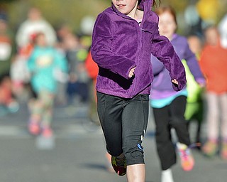 Jeff Lange | The Vindicator  Karley Gerst (7) of Canfield races down the street as she participates in the children's 400 meter race, Sunday morning before the start of the 10K Peace Race in the streets of Youngstown. Karley is the daughter of Brian and Shawne Gerst.