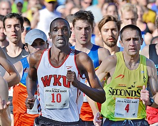 Jeff Lange | The Vindicator  Patrick Cheptoek (10) of Bowling Green leads the pack from the starting line during the Peace Race 10K competition held in Youngstown, Sunday morning. Cheptoek went on to capture first place.