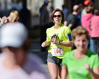 Jeff Lange | The Vindicator Erin Burns of Masury (166) trails behind her competition as she approaches the finish line in Sunday's 2014 Peace Race 10K in Youngstown.