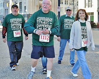 Jeff Lange | The Vindicator  Despite living through 4 strokes, former Vindicator sports writer Bill Sullivan (1112) is accompanied by friends and family Michael Laboy (599) of Campbell and Lucy Flask (369) as he walks in the 2 mile competition of Sunday's Peace Race.