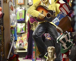 Katie Rickman | The Vindicator.A 6 ft tall Elvis statue faces the hallway leading to Quincy's Costumes in Youngstown on Tuesday, Oct. 21, 2014. The shop has a 50's feel to it and even has a vintage 1964 Cord car on display.