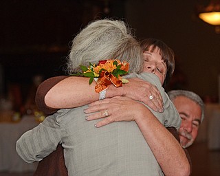 Katie Rickman | The Vindicator Becky Dearing-Wall embraces her mother Carol Dearing after addressing a group gathered at a banquet honoring her achievement as “Woman of the Year” at Antone’s Banquet Center in Boardman on Tuesday, Oct. 21, 2014.