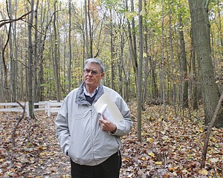        ROBERT K. YOSAY  | THE VINDICATOR..Standing on one of the new paths with the fern area behind him.Mike Heher, chairman of the park board, at the Poland Twp Park talks about the 20+ new species of trees that have been added to the park since it opened in 2009.as wellas trails, fern area and butterfly area.  ..-30-
