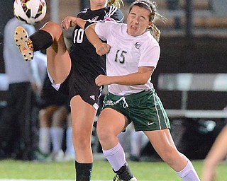 Jeff Lange | The Vindicator  Canfield's Sydney Miller (10) kicks the ball as she is pressured by Lake's Sammy Salatino (15) in the first half of their Regional Semi-Final matchup at Brush High School in Lyndhurst, Tuesday night.