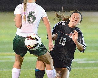 Jeff Lange | The Vindicator  Canfield's Candace Smith (13) trips as she kicks the ball through the legs of Lake defender Nicole Bush (6) during first half action at Brush High School, Tuesday night.