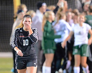 Jeff Lange | The Vindicator  Canfield senior team captain Sydney Miller (10) weeps after being ousted from the regional tournament as opponents from Lake Catholic celebrate their 1-0 overtime victory at Brush High School, Tuesday night.