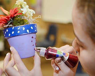 Katie Rickman | The Vindicator .Students at Akiva Academy in Youngstown decorate pots at the academy on Thursday, Oct. 23, 2014. The Students will distribute the decorative pots on on Mitvah Day.