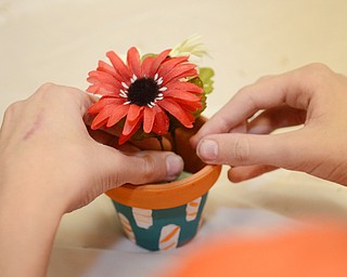 Katie Rickman | The Vindicator .Students at Akiva Academy in Youngstown decorate pots at the academy on Thursday, Oct. 23, 2014. The Students will distribute the decorative pots on on Mitvah Day.