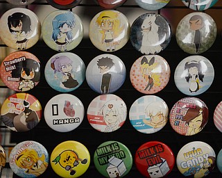 Katie Rickman | The Vindicator .Stickers, books, buttons, and patches are among the many items made by Black Street Entertainment owners Justin and Terry Raimey of Youngstown.  Small buttons are shown here on display.