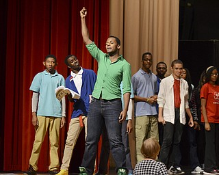 Katie Rickman | The Vindicator.Josh Green who plays the part of Colehouse Walker, Jr. in the collaborative production of Ragtime raises his hand and sings out lines for the upcoming musical at Chaney High School on Thursday, Oct. 23, 2014.  The musical is a collaborative production combining students from Canfield and Chaney.