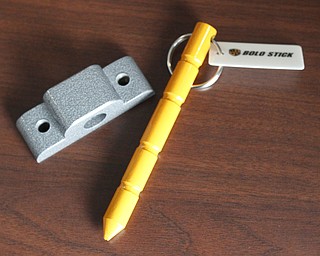        ROBERT K. YOSAY  | THE VINDICATOR..William Barna - shows off BOLO STICK at a YSU press conference- its for locking classroom doors ..-30-