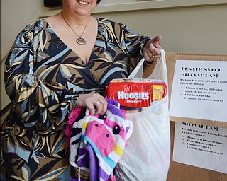 Katie Rickman | The Vindicator .Mari Alschuler holds items donated to Congregation Rodef Sholom in Youngstown for the upcoming good deed day on Thursday, Oct. 23, 2014 at the temple.