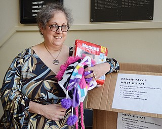 Katie Rickman | The Vindicator .Mari Alschuler holds items donated to Congregation Rodef Sholom in Youngstown for the upcoming good deed day on Thursday, Oct. 23, 2014 at the temple.