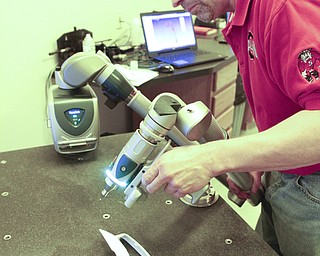        ROBERT K. YOSAY  | THE VINDICATOR..Scanning in a part into the printer is Bill Hallewell... .of salem.. Printing 3-D Parts is a commercial enterprise that uses 3-D printing and scanning technologies in production for the packaging and container industries. The company claims to be the first of its kind in the Mahoning Valley....-30-