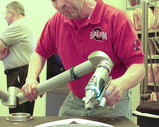        ROBERT K. YOSAY  | THE VINDICATOR..Scanning in a part into the printer is Bill Hallewell... .of salem.. Printing 3-D Parts is a commercial enterprise that uses 3-D printing and scanning technologies in production for the packaging and container industries. The company claims to be the first of its kind in the Mahoning Valley....-30-