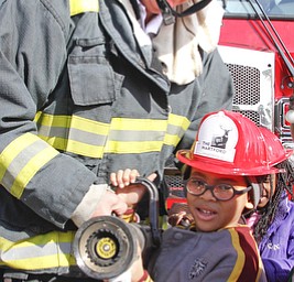        ROBERT K. YOSAY  | THE VINDICATOR..Robert Huffman  helps hold a fire house with  Capt Bob Catchpole... as he explains the FD fire truck..Kindergarten students from  E J BLOTT in Liberty head out with red fire hats from Gibson Insurance who sponsored the event with the Red Cross and  Liberty FD ...-30-