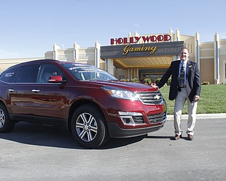        ROBERT K. YOSAY  | THE VINDICATOR..The Chevy Traverse, provided by a Chevy dealer from Bowling Green will be the grand prize drawn for at 9 p.m. on Nov. 23 at Hollywood Gaming at Mahoning Valley Race Course. If the winner does not pick the car, they can take cash, free play or a Chevy of equal or lesser value as alternatives. Scott Frost shows off the Traverse..-30-