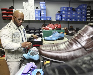 William D. Lewis The vindicator  Andre Morgan, owner of Two Guys, a downtown Youngstown clothing store at work.