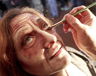 William D. Lewis the Vindicator   Melinda Franko of Lake Milton gets make up applied by Greg Lanning of G.D. Effects before Zombie Crawl in downtown Youngstown 10-25-14.