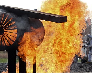 William D Lewis the Vindicator  Firefighter extinguish a blaze after a mock plane crash at Youngstown Air Force Reserve Base Monday 10-27-14. Base firefighter along firefighters from area departmentw and The Red Cross participated in the event.