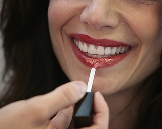        ROBERT K. YOSAY  | THE VINDICATOR...Lucia carns touches up Cristina Memo ..A locally-owned beauty shop in Boardman recently opened a new location and offers a variety of services from airbrush makeup to extensions and tanning. , has expanded her client base through social media and her work. She does her work with an all-natural makeup she sells at her shop..-30-