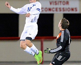 Jeff Lange | The Vindicator  Poland's Anthony Sabula (10) jumps to head the ball as Marlington defender Dillon Wright (right) watches from below, during first half action at Art Wright Stadium in Wadsworth, Wednesday night.