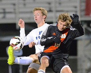 Jeff Lange | The Vindicator  Poland's David Watson (left) kicks the ball over the defense of Marlington's Andrew Hoffmeyer (19) in the first half of their Wednesday night semi final matchup in Wadsworth.