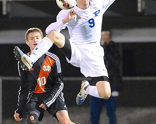 Jeff Lange | The Vindicator  Poland's Ryan Weitzman (9) knees the ball over his head as Marlington defender Jordan Boehm (10) looks on from behind in their contest, Wednesday night at Art Wright Stadium in Wadsworth.