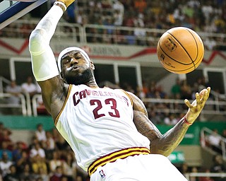 The Cavaliers’ LeBron James dunks during a preseason game at the NBA Global Games in Riode Janeiro, Brazil. James returns to play his first regular-season game with the Cavaliers tonight, and it will be a night unlike any other in Cleveland sports history as in four years, with any bitterness toward James having been replaced with forgiveness by a city thirsting for a championship.