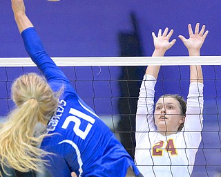 Jeff Lange | The Vindicator  Mooney senior McKenzie Reese 924) puts up a defense as Gilmour Academy's Laura Brzozowski (21) puts the ball over the net during Thursday night's regional semi final match in Barberton.