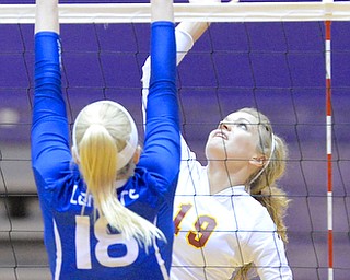 Jeff Lange | The Vindicator  Mooney's Maddie Abrigg (19) spikes the ball over the net as Gilmour Academy's Julia Brzozowski (18) defends the shot, Thursday night in Barberton during the regional semi finals.