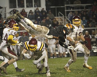  .          ROBERT  K. YOSAY | THE VINDICATOR..#11 Springfield Ryan Kohler is upended  by SR #25 Nick Stantonas #24 Taymer Graham and #19  Ryan Miller look on ....South Range took an early lead and never looked back as week 10 is in the books....-30-