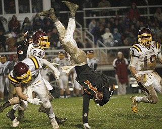  .          ROBERT  K. YOSAY | THE VINDICATOR..#11 Springfield Ryan Kohler is upended  by SR #25 Nick Stantonas #24 Taymer Graham and #19  Ryan Miller look on ....South Range took an early lead and never looked back as week 10 is in the books....-30-