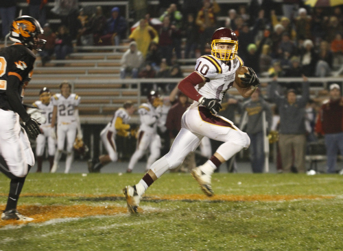 .          ROBERT  K. YOSAY | THE VINDICATOR..#10 SR Greg Dunham takes off on his run for a TD a in the first quarter as Springfireld  24 Cory Stouffer can only watch..South Range took an early lead and never looked back as week 10 is in the books....-30-