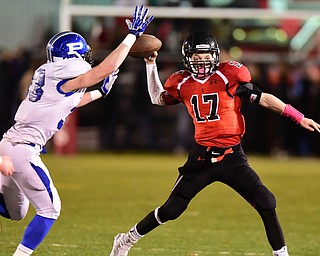 CANFIELD, OHIO - OCTOBER 31, 2014: Aaron Jenkins #17 of Canfield roost out to pass while avoiding pressure from Poland #33 (name not on any roster that I could find or have) during the 3rd quarter of Friday nights OHSAA football game. (Photo by David Dermer/Youngstown Vindicator)