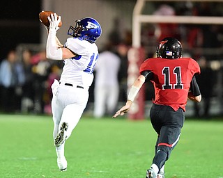 CANFIELD, OHIO - OCTOBER 31, 2014: Tyler Smith #12 of Poland catches a long pass after getting behind Troy Williams #11 of Canfield during the 3rd quarter of Friday nights OHSAA football game. (Photo by David Dermer/Youngstown Vindicator)