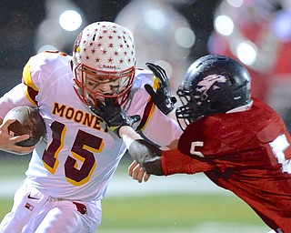 Jeff Lange | The Vindicator  Mooney quarterback Jon Saadey (15) is shoved out of bounds by Fitch defender Carlos Herriott (5) in the second quarter of their matchup, Friday night in Austintown.