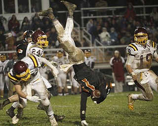 ROBERT  K. YOSAY | THE VINDICATOR..#11 Springfield Ryan Kohler is upended  by SR #25 Nick Stantonas #24 Taymer Graham and #19  Ryan Miller look on ....South Range took an early lead and never looked back as week 10 is in the books