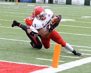 YOUNGSTOWN, OHIO - NOVEMBER 1, 2014: Jasper Sanders #3 of South Dakota dives for the pylon to score a touchdown before being brought down by Jaylin Kelly #40 of YSU during the 1st half of Saturday afternoon NCAA football game at Stambaugh Stadium. YSU won 28-17. (Photo by David Dermer/Youngstown Vindicator)