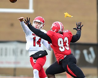 YOUNGSTOWN, OHIO - NOVEMBER 1, 2014: Kevin Earl #14 of South Dakota throws the football while avoiding pressure from Emmanuel Kromah #93 of YSU during the 1st half of Saturday afternoon NCAA football game at Stambaugh Stadium. YSU won 28-17. (Photo by David Dermer/Youngstown Vindicator) *The flag would be a hold on SD*