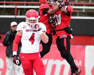 YOUNGSTOWN, OHIO - NOVEMBER 1, 2014: Jody Webb #20 and Andre Stubbs #4 of YSU celebrate after a touchdown run by Webb during the 1st half of Saturday afternoon NCAA football game at Stambaugh Stadium. YSU won 28-17. (Photo by David Dermer/Youngstown Vindicator) Ryan Hillier #4 of South Dakota pictured.