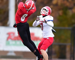 YOUNGSTOWN, OHIO - NOVEMBER 1, 2014: Jelani Berassa #8 of YSU leaps to catch a pass behind Joey Cejudo #17 of South Dakota during the 1st half of Saturday afternoon NCAA football game at Stambaugh Stadium. YSU won 28-17. (Photo by David Dermer/Youngstown Vindicator)