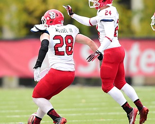 YOUNGSTOWN, OHIO - NOVEMBER 1, 2014:  John Wessel #28 is congratulated by teammate Jacob Warner #24 of South Dakota after a interception by Wessel during the 1st half of Saturday afternoon NCAA football game at Stambaugh Stadium. YSU won 28-17. (Photo by David Dermer/Youngstown Vindicator)