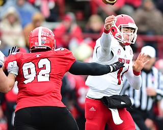 YOUNGSTOWN, OHIO - NOVEMBER 1, 2014:Kevin Earl #14 of South Dakota throws a pass from the pocket while avoiding pressure from octavius Brown #92 of YSU during the 1st half of Saturday afternoon NCAA football game at Stambaugh Stadium. YSU won 28-17. (Photo by David Dermer/Youngstown Vindicator)
