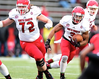 YOUNGSTOWN, OHIO - NOVEMBER 1, 2014: Jasper Sanders #3 of South Dakota runs the football behind Andrew Schofield #72 during the 2nd half of Saturday afternoon NCAA football game at Stambaugh Stadium. YSU won 28-17. (Photo by David Dermer/Youngstown Vindicator)