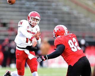 YOUNGSTOWN, OHIO - NOVEMBER 1, 2014:Kevin Earl #14 of South Dakota throws a pass from the pocket while avoiding pressure from octavius Brown #92 of YSU during the 2nd half of Saturday afternoon NCAA football game at Stambaugh Stadium. YSU won 28-17. (Photo by David Dermer/Youngstown Vindicator)