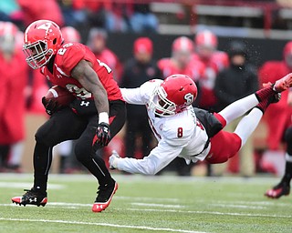 YOUNGSTOWN, OHIO - NOVEMBER 1, 2014: Martin Ruiz #29 of YSU runs the football while Tyson Graham Jr. #8 of South Dakota attempts to tackle him during the 2nd half of Saturday afternoon NCAA football game at Stambaugh Stadium. YSU won 28-17. (Photo by David Dermer/Youngstown Vindicator)